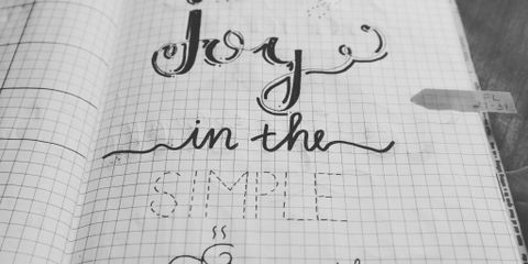 Black and white image of a handwritten inspirational quote on a notebook page.