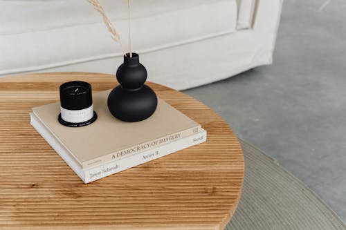 Vase and Candle Standing on Stack of Books