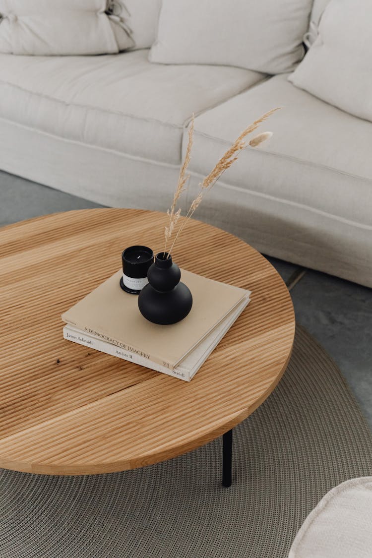 Books Vase And Candle On Short Coffee Table