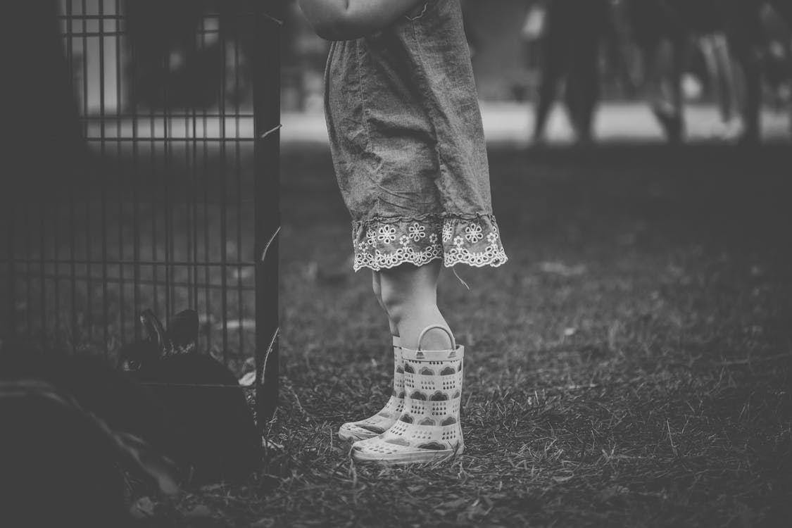 Monochrome Photography of Children Wearing Boots