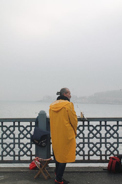 Elderly Man in Yellow Raincoat