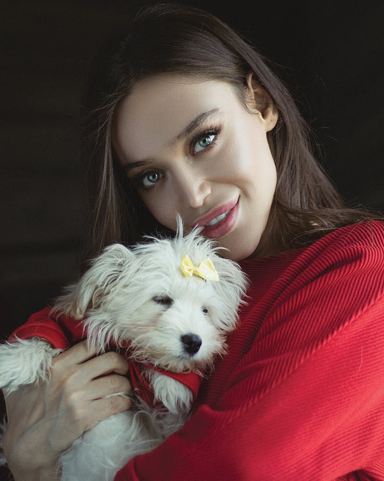 Pretty Woman Cuddling A Cute White Puppy