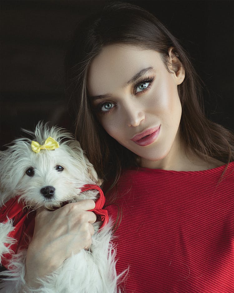 Pretty Woman Holding A Cute White Puppy