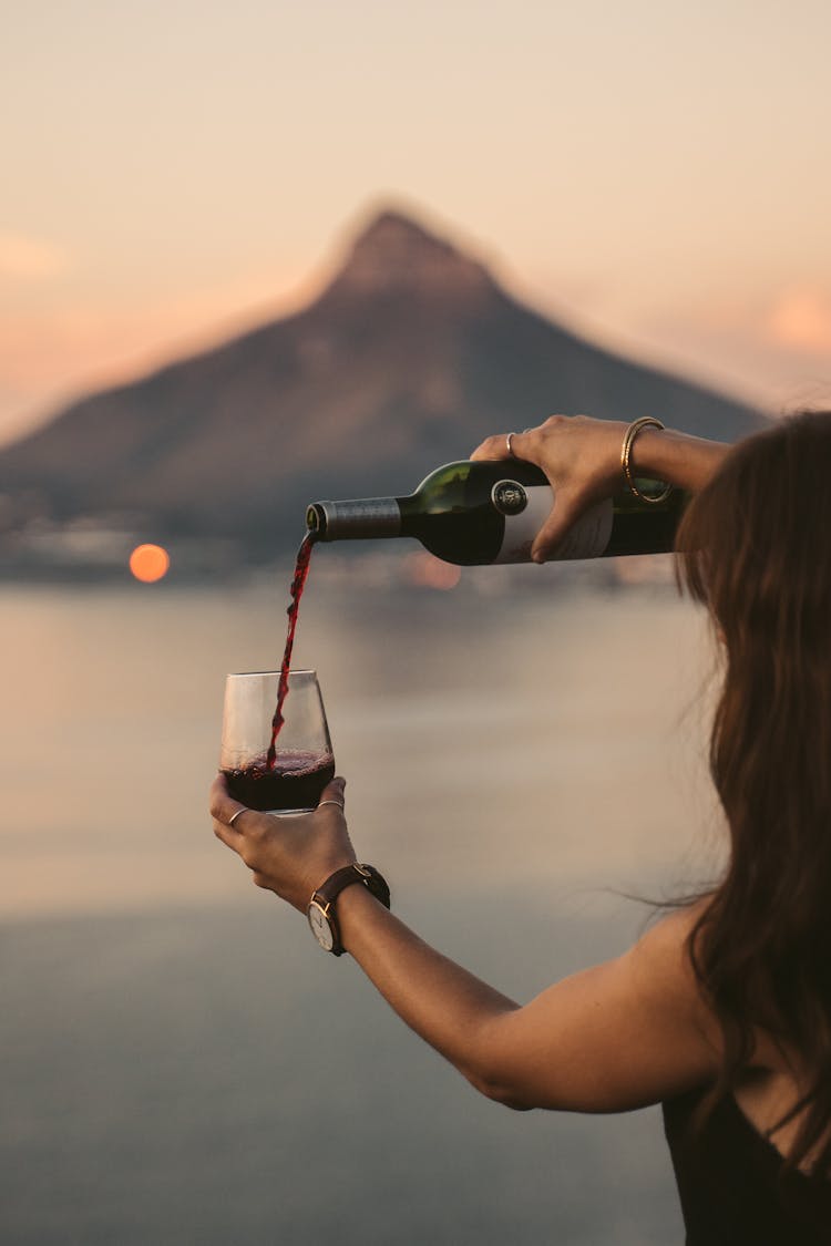 Woman Pouring Wine In A Glass