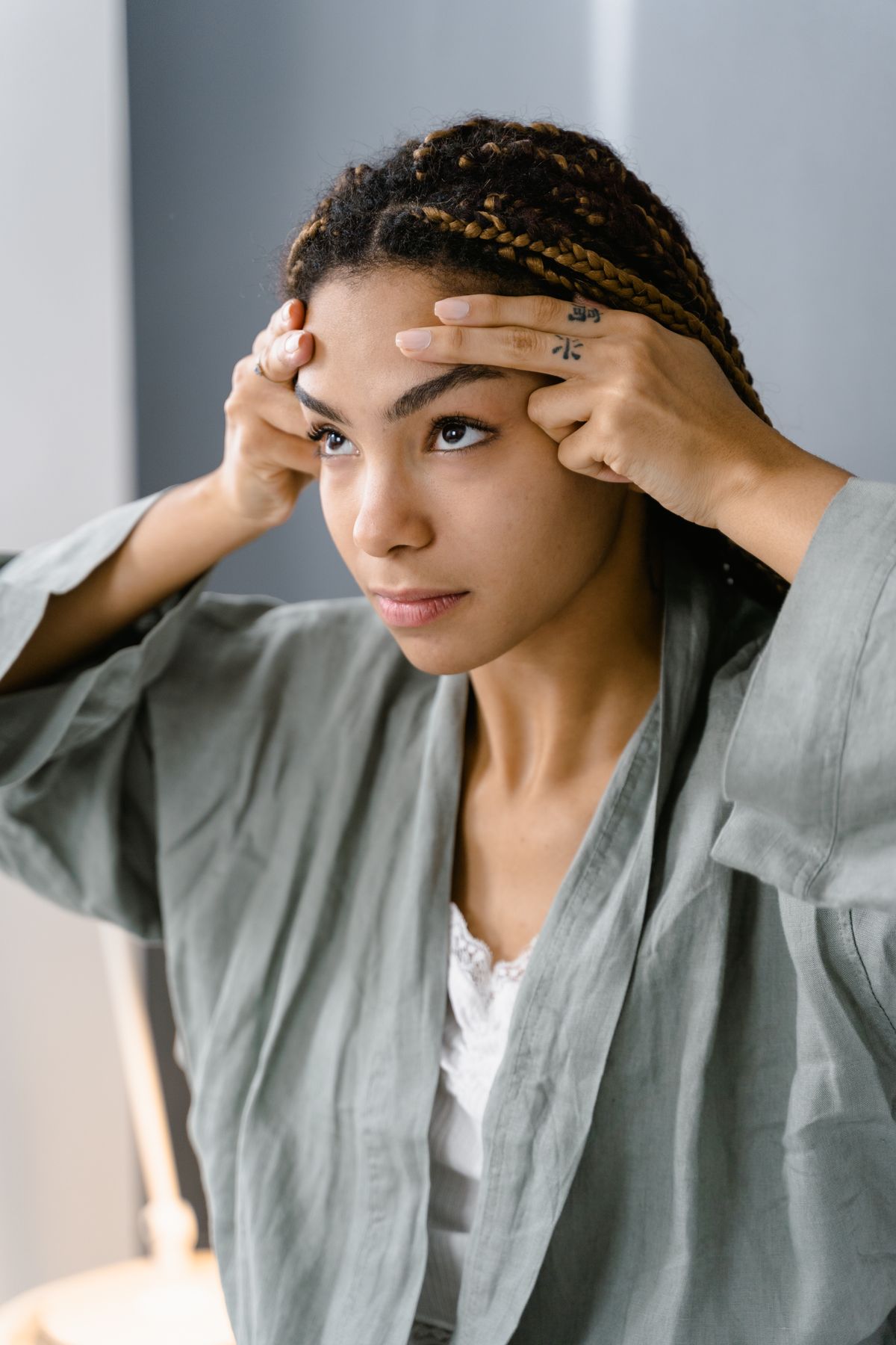 Young woman doing facial massage for skin care