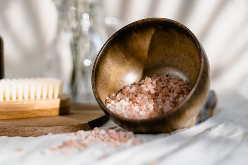 Free Himalayan pink salt in a rustic wooden bowl for spa or skincare rituals. Stock Photo
