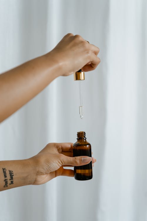 A Person Holding a Brown Bottle