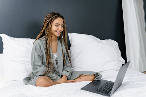Free A Woman Sitting on the Bed Stock Photo