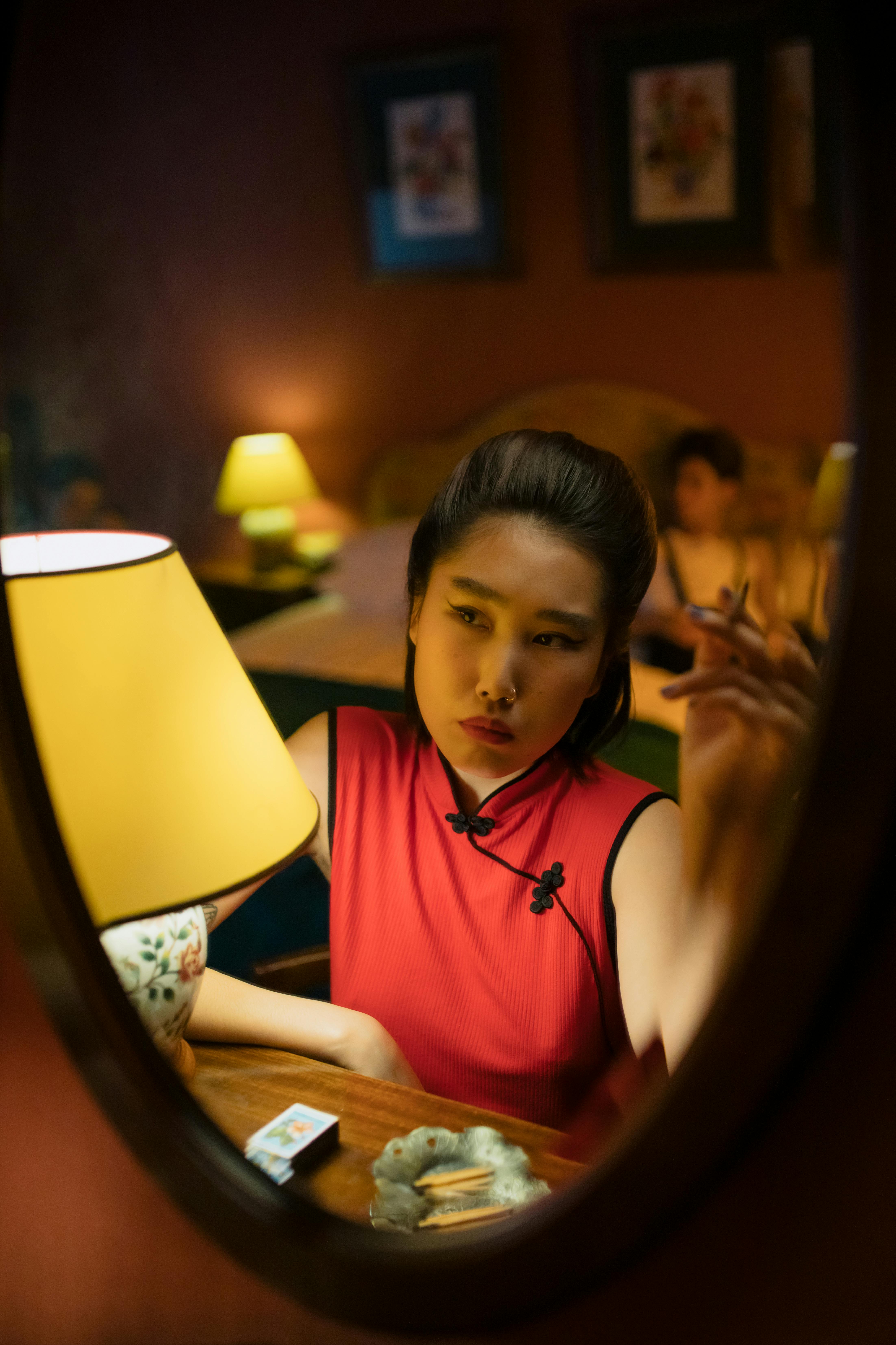 woman in front of the mirror smoking