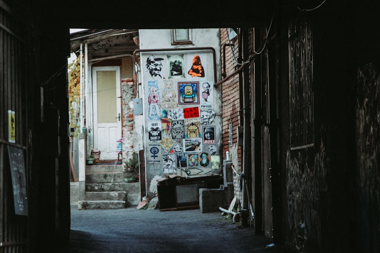 Colorful Posters On The Wall Of An Old Building 