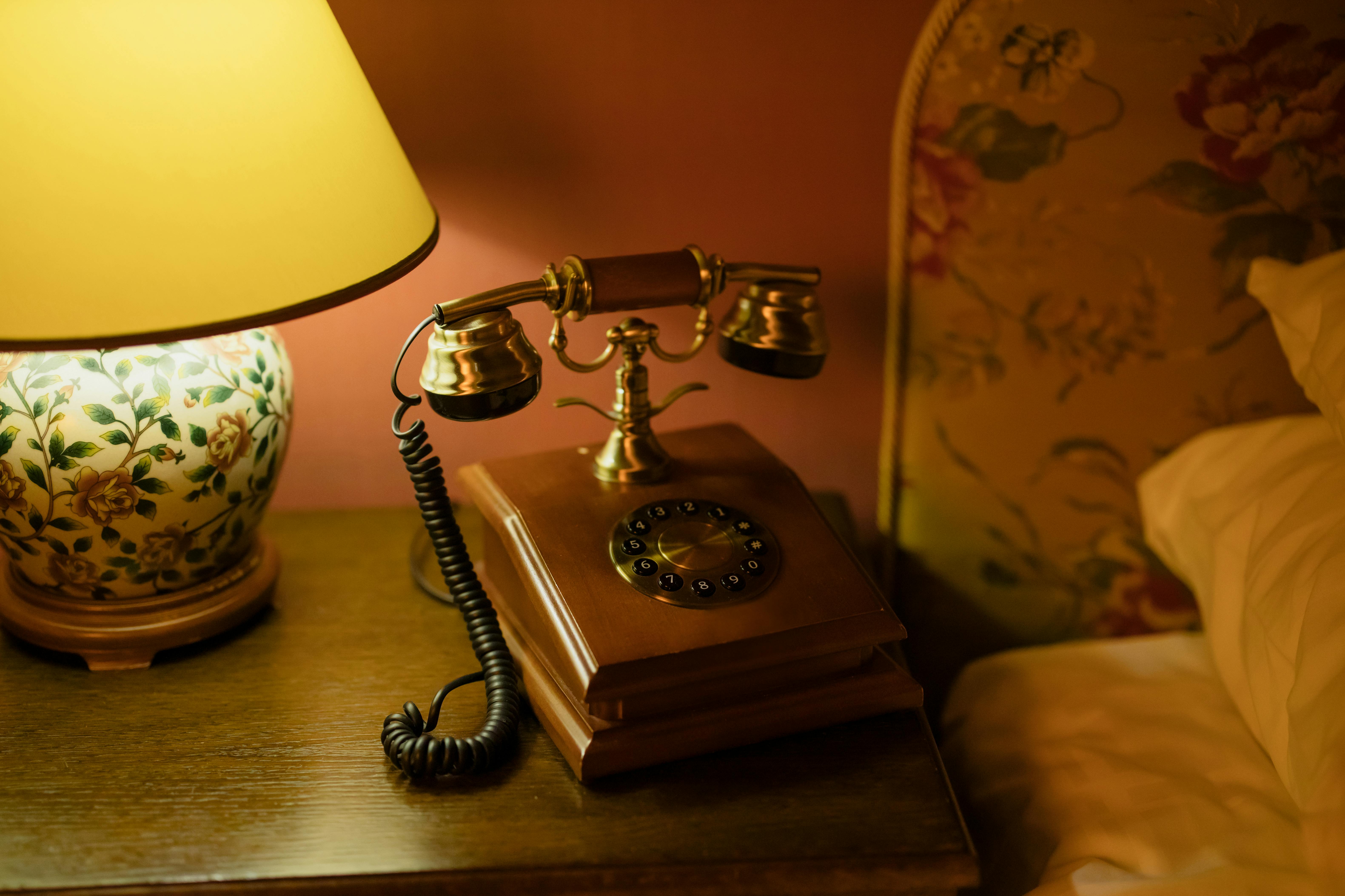 vintage telephone beside the bed