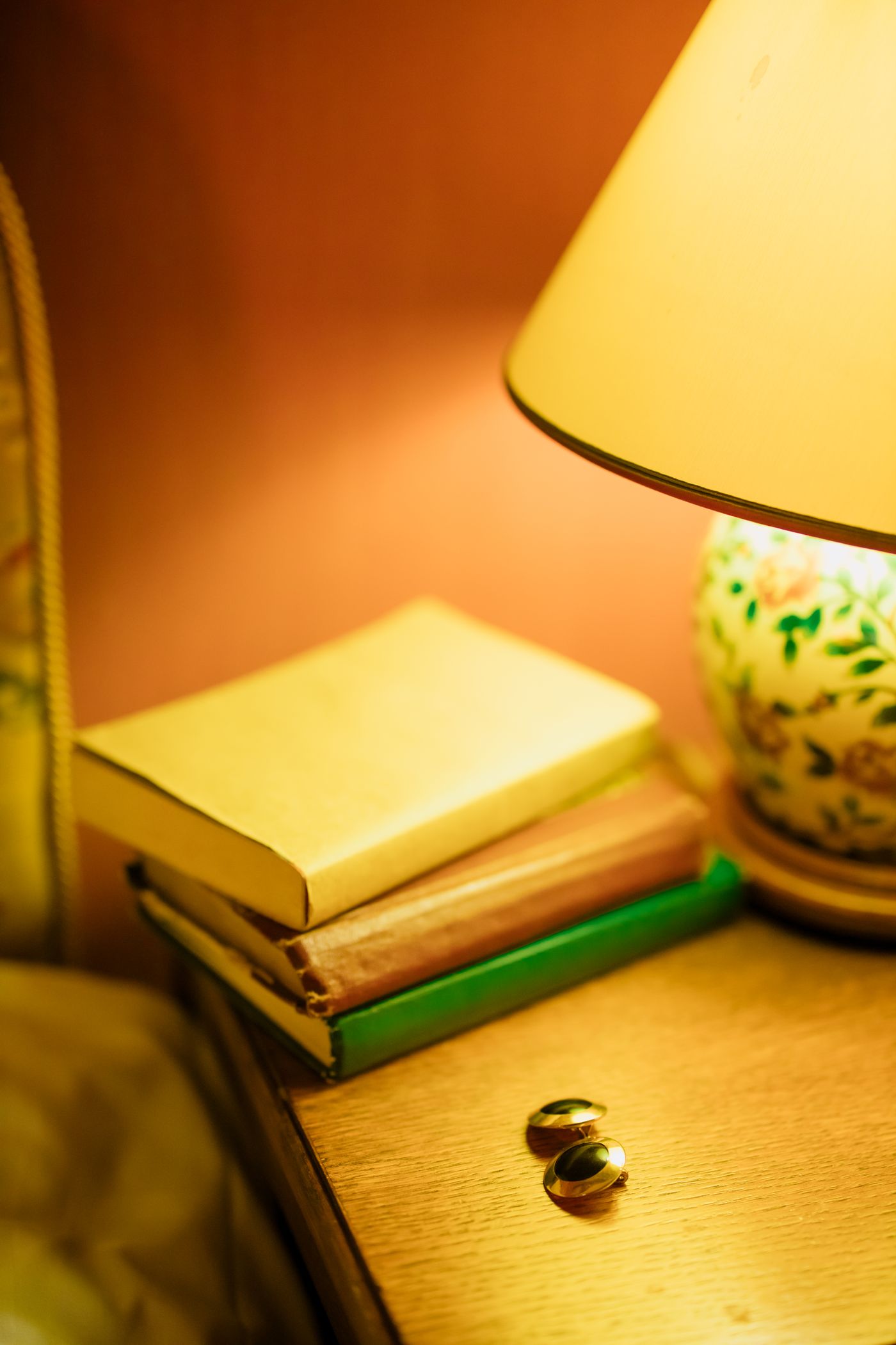 Stack of books beside a lamp