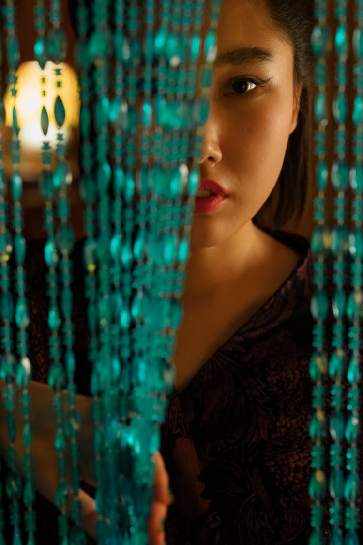 Woman Behind Beaded Curtain