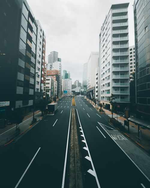 Free Aerial shot of a bustling city street flanked by modern skyscrapers. Stock Photo