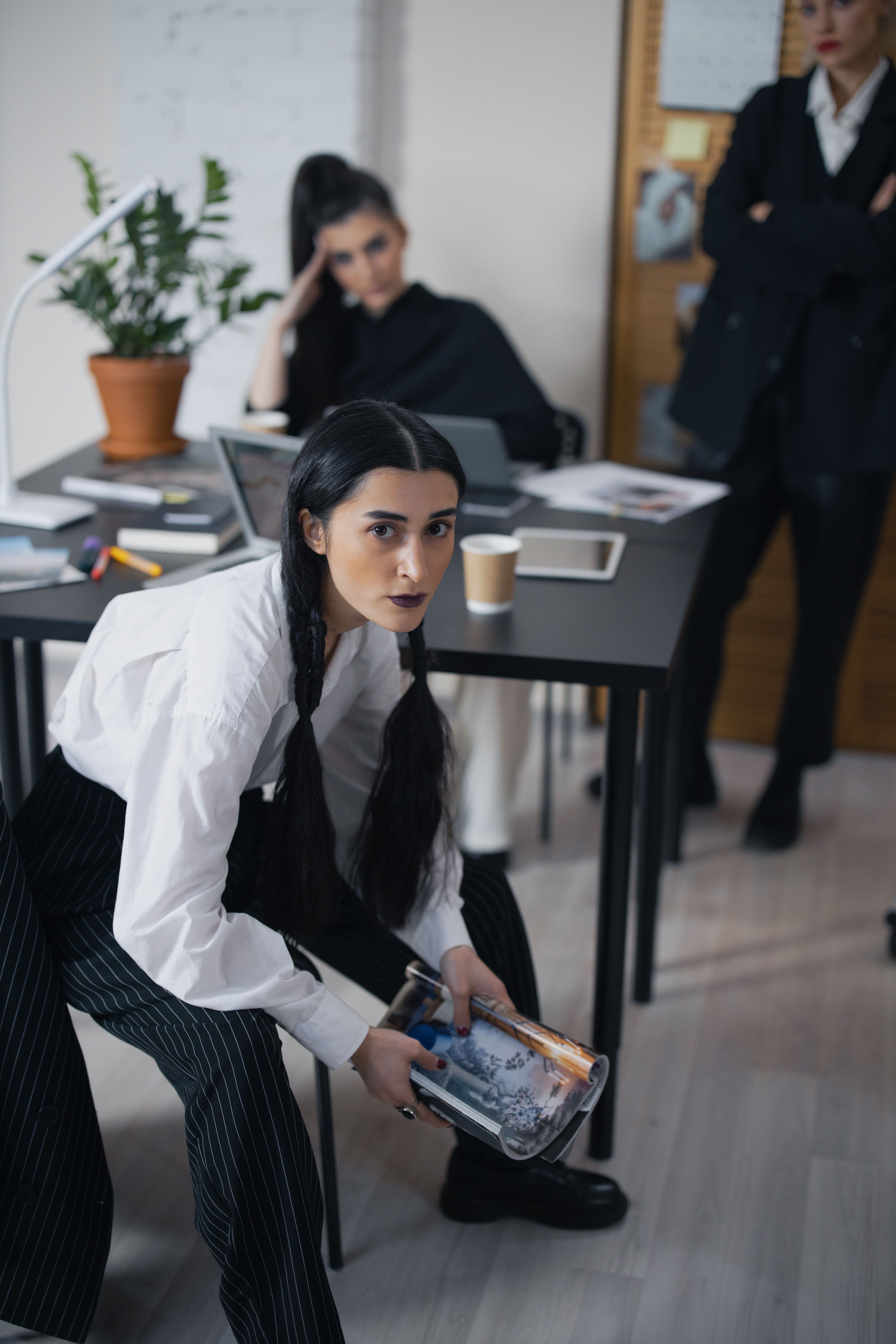 Woman in White Long Sleeve Shirt Sitting Near Black Table · Free Stock ...