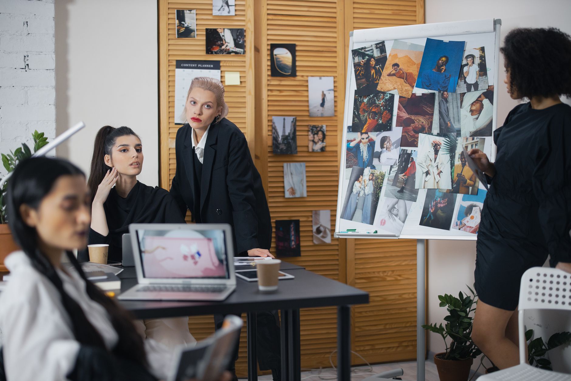 Team discussing ideas around a desk in an office collaboration session.