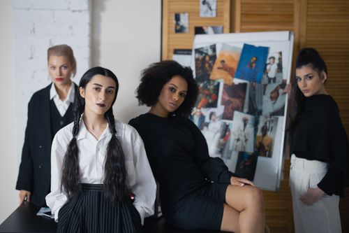 Free Diverse group of women displaying strength and style in a fashion studio setting. Stock Photo