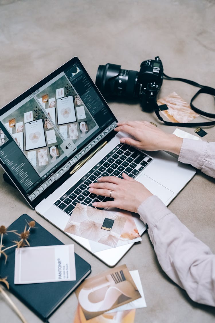 A Person Using A Laptop For Editing