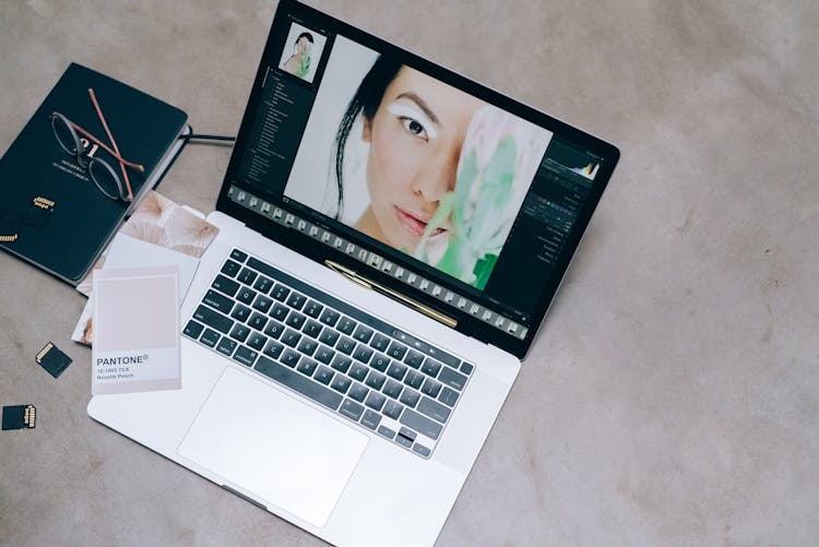 Laptop Beside A Black Notepad