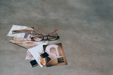 Photo prints, glasses and memory cards on concrete, photo by Leeloo The First on Pexels