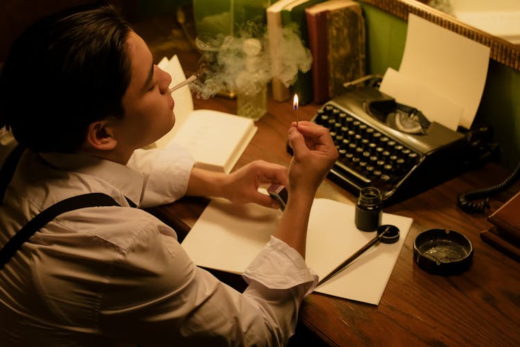 Man Smoking Holding A Matchstick