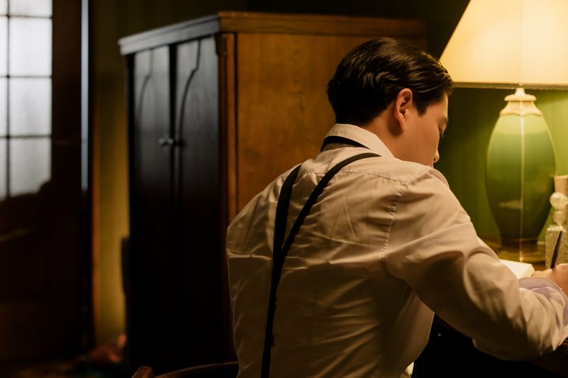 Writing in a notebook by lamplight — photo by cottonbro studio on Pexels