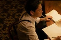 Man in White Dress Shirt Sitting and Smoking