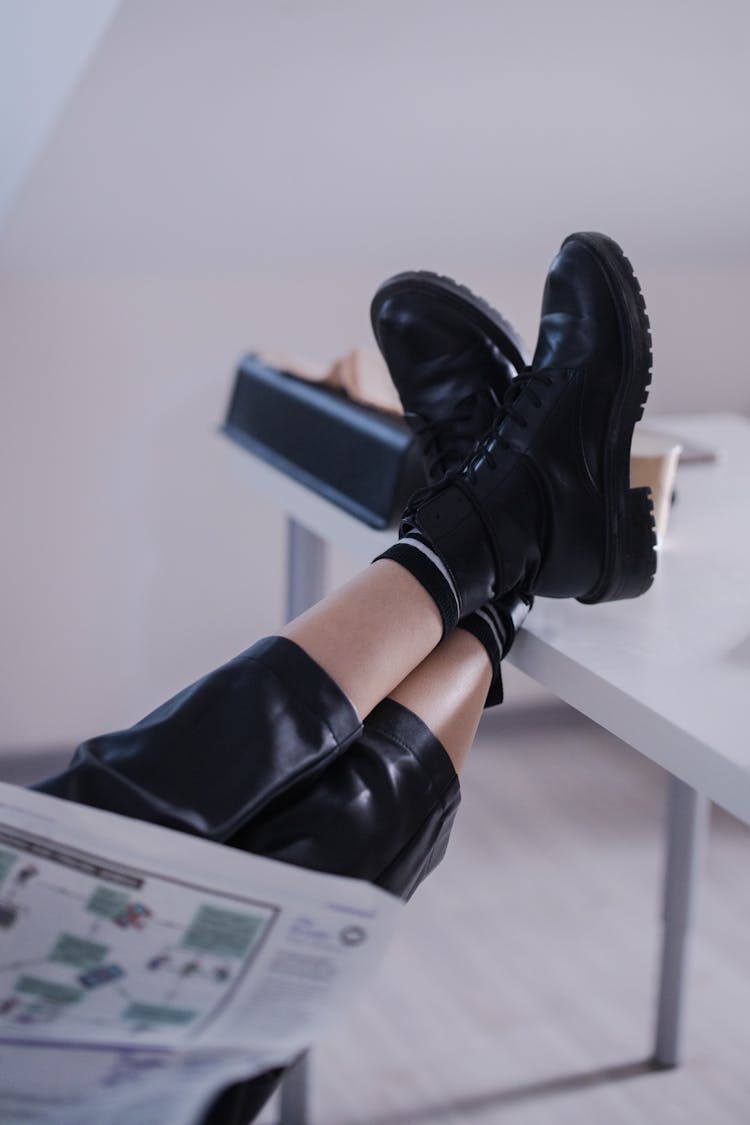 Feet In Black Books On Table