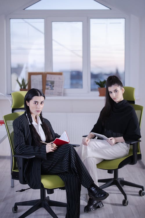 Women Sitting on the Chair while Looking with a Serious Face