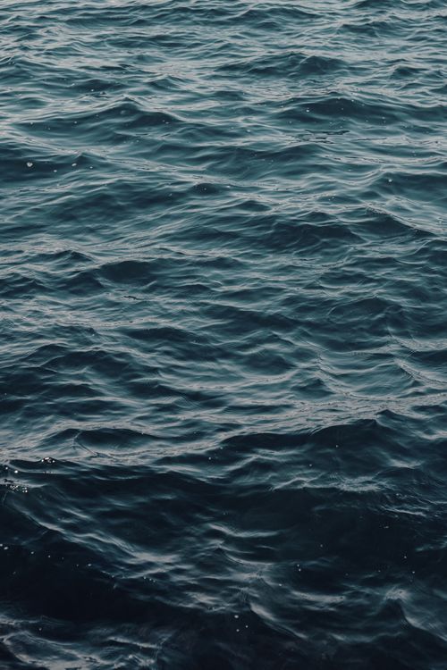 Free Serene sea waves captured under soft twilight light with a textured water surface. Stock Photo