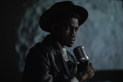 Man in Black Leather Jacket Holding Microphone