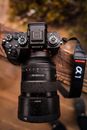 Black Nikon Dslr Camera on Brown Wooden Log