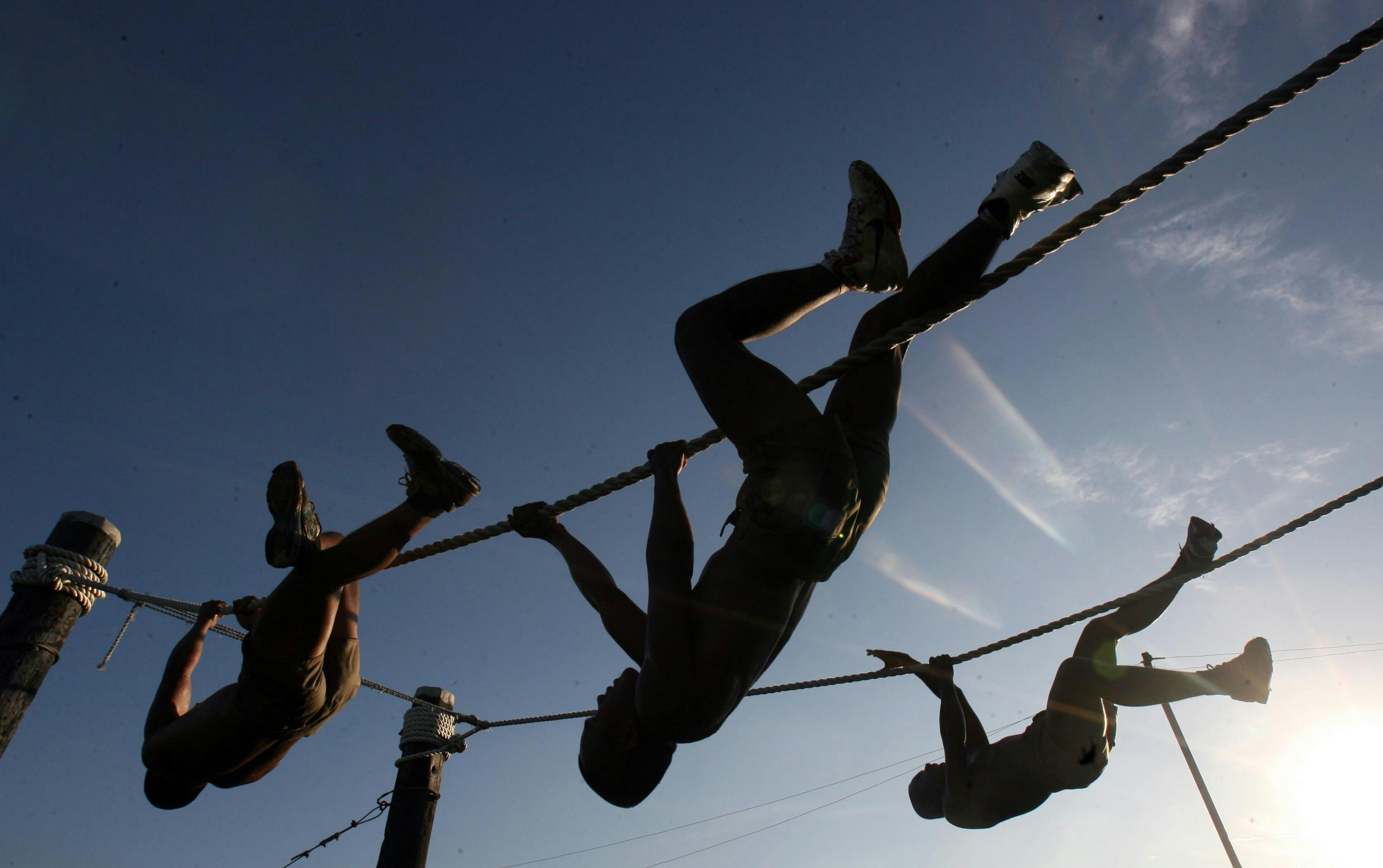Three Man Climbing on Rope Under the Sunset · Free Stock Photo