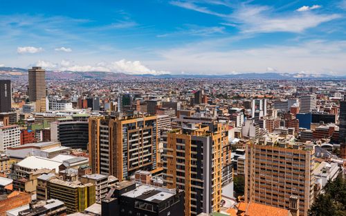 Free Aerial view of Bogotá's skyline with skyscrapers under a clear blue sky. Stock Photo