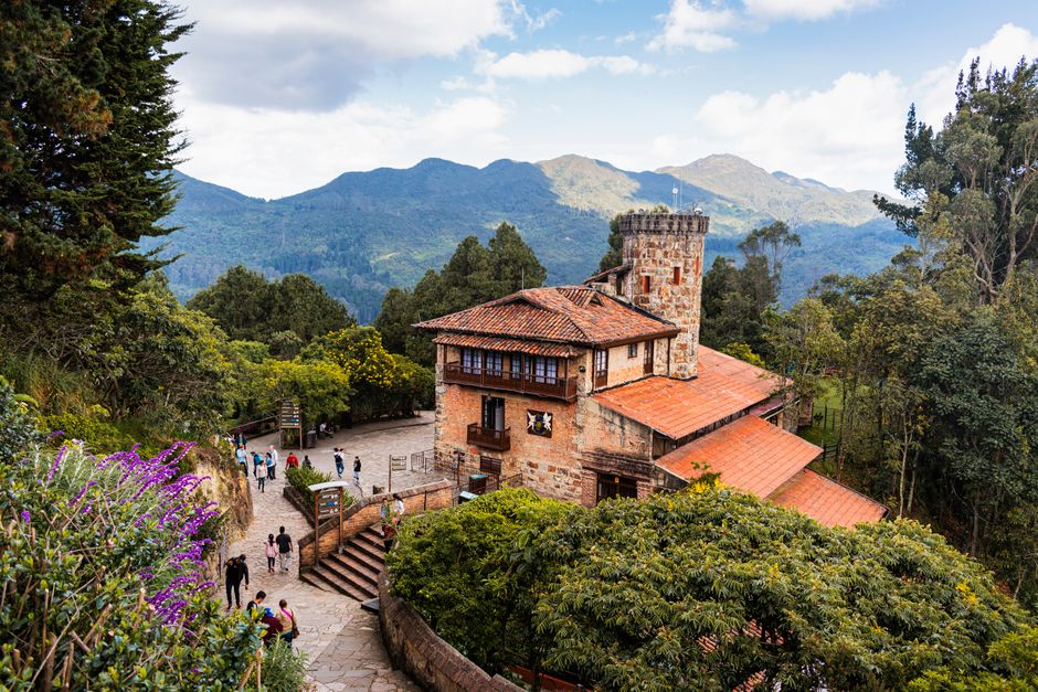 Charming stone building amidst lush greenery on Monserrate Hill, Bogotá, Colombia.