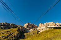Spectacular scenery of cable way leading to Sass Pordoi mountain placed in Italy under cloudless blue sky in sunny day