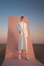 Man in White Coat Standing on Pink Background