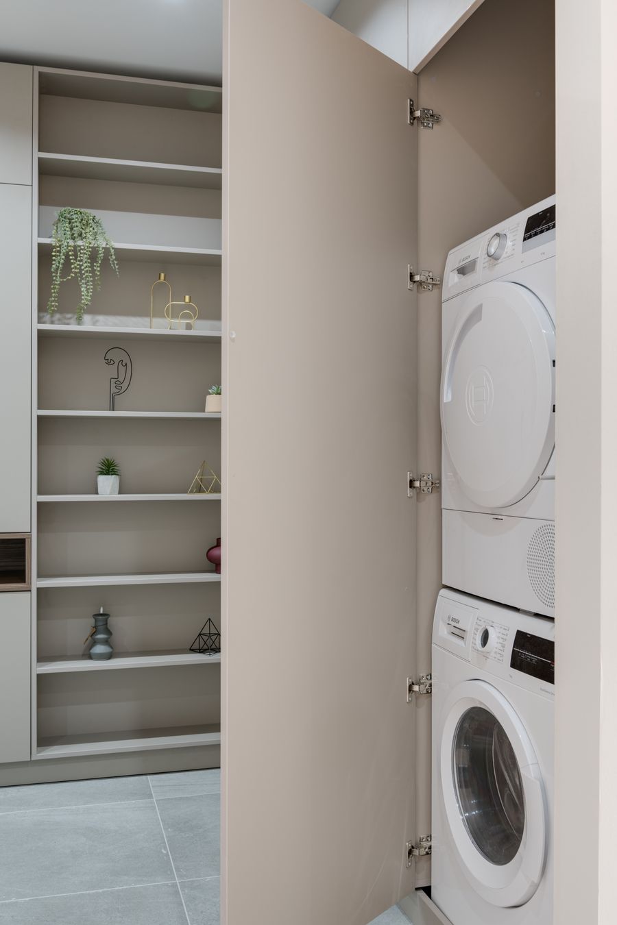 Washer and dryer set installed in a home laundry cabinet