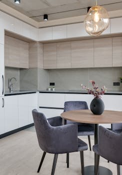 Contemporary kitchen interior with sleek furniture and stylish lighting in a modern apartment.