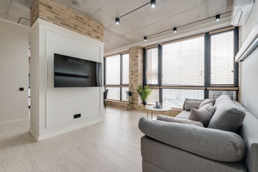 Spacious living room featuring modern design, natural light, and stylish decor for a cozy atmosphere.