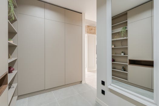 Explore this sleek and modern corridor featuring minimalist design with built-in wardrobes and stylish shelves.