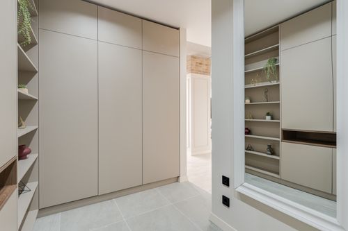 Free Explore this sleek and modern corridor featuring minimalist design with built-in wardrobes and stylish shelves. Stock Photo