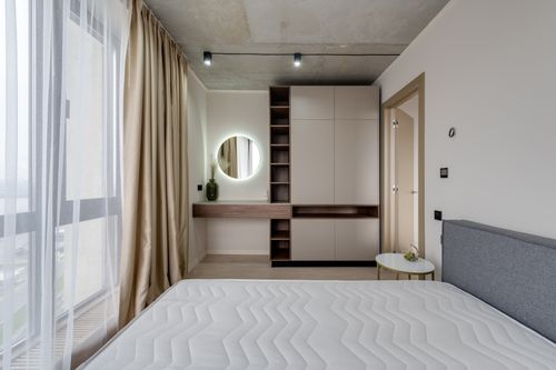 Free Contemporary bedroom with large window, modern furniture, and stylish decor. Stock Photo