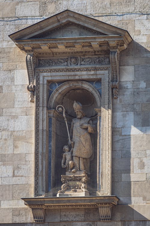 Statue of Saint Augustine in niche on wall of Catholic St Stephens Basilica in Budapest