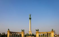 Low angle of Heroes Square and column with Archangel Gabriel on top against colonnades in Budapest