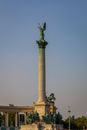 Low angle of aged stone column with Seven chieftains of Magyars on pedestal and statue on top on Heroes Square in Budapest
