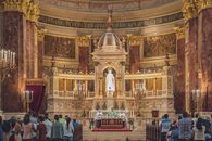 Majestic interior of St. Stephen's Basilica in Budapest during mass service.