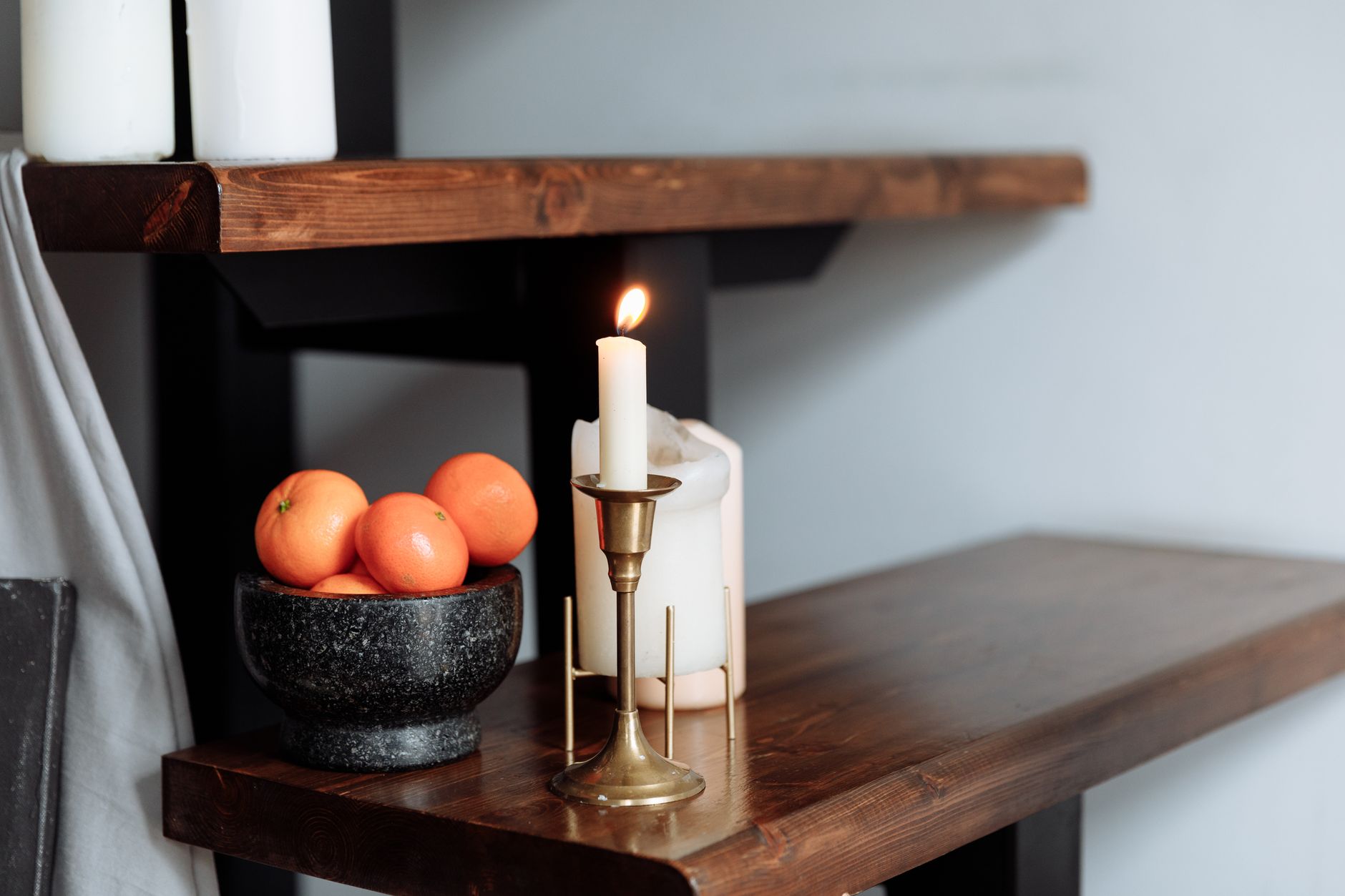 collection of candles on wooden shelf