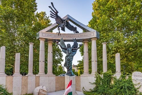 Free Monument in Budapest honoring victims of German occupation, featuring angelic statue. Stock Photo