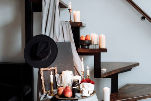Free A moody Halloween display featuring candles, skulls, and decor on a staircase, evoking traditional celebration vibes. Stock Photo